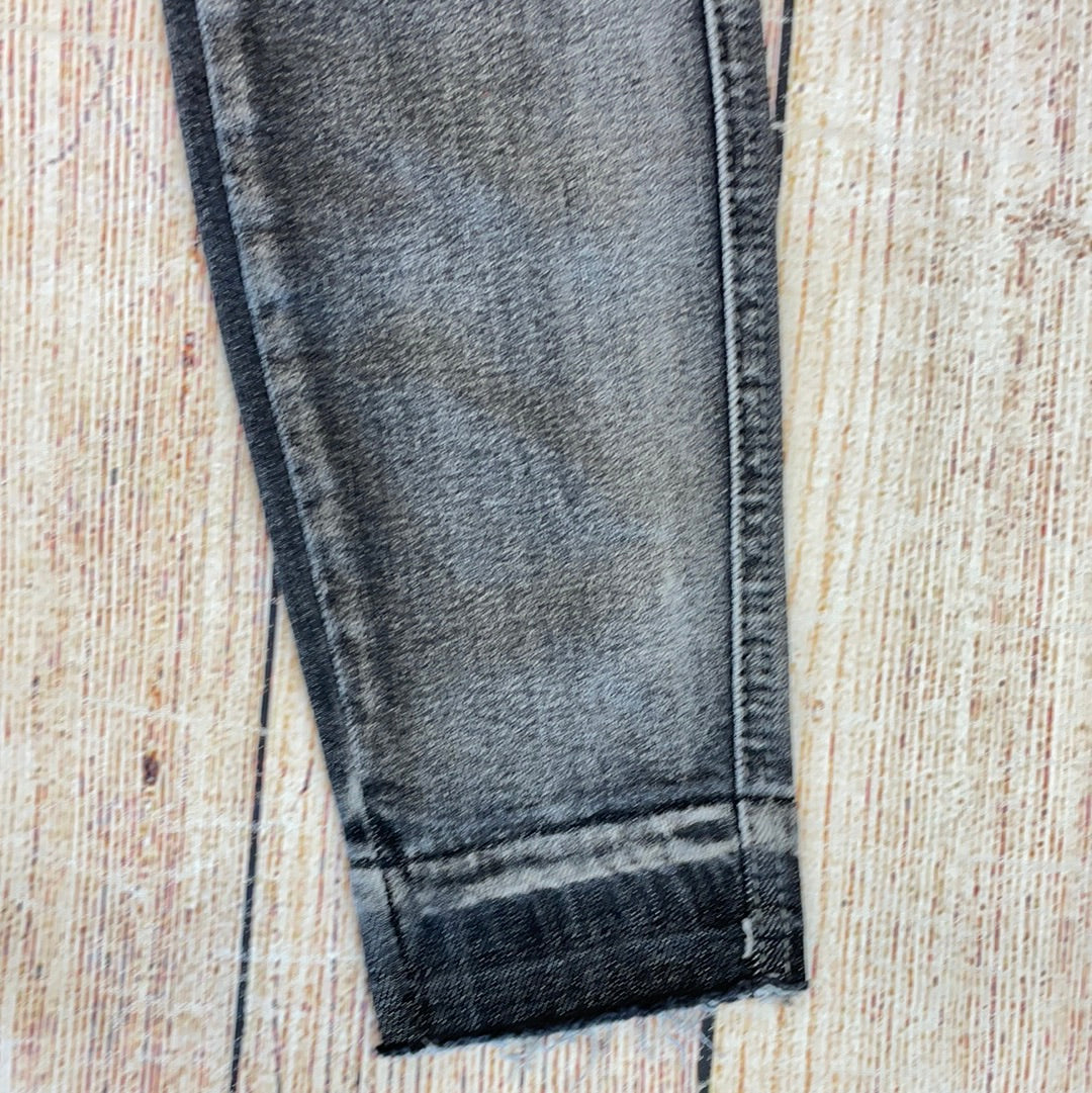 Judy Blue gray high-waisted jeans with heavy sanding.